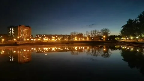 Night. Multi-storey buildings, lanterns, trees are reflected in the water.4к Stock-Footage 162045235