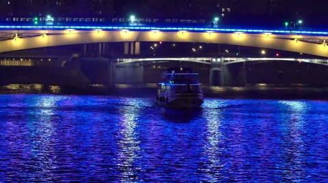 Night navigation on the Moscow river. View of the the metro bridge, Stock Footage 65478042