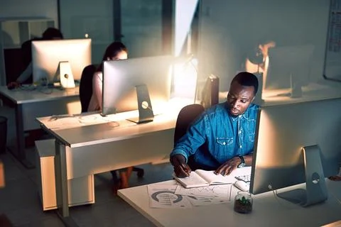 Night, notes and man with computer in office for research, planning and data at Stock Photos