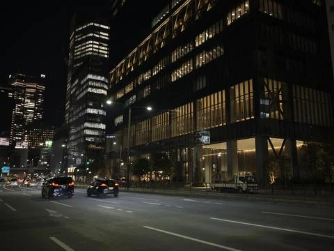 Night office districts with light trails and lit glass buildings, Japan Stock Photos