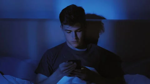Night online insomnia problem bored guy phone bed Stock Footage 149126424