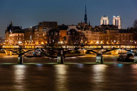 Night Paris, reflection of lights in the river Seine, cityscape Stock Photos