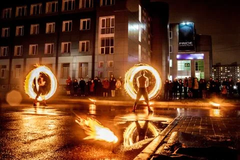 Night performance fire show in front of a crowd of people on the street in Ru Stock Photos