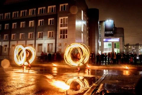Night performance fire show in front of a crowd of people on the street in Ru Stock Photos