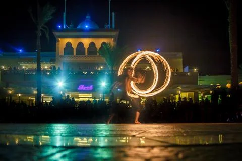 Night performance fire show in front of a crowd of people on the street in Eg Stock Photos