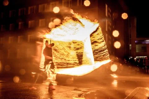 Night performance fire show in front of a crowd of people on the street in Ru Stock Photos
