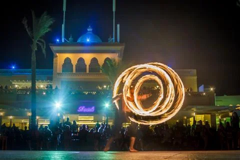 Night performance fire show in front of a crowd of people on the street in Eg Stock Photos