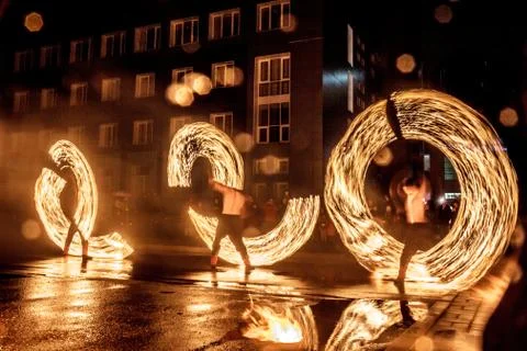 Night performance fire show in front of a crowd of people on the street in Ru Stock Photos