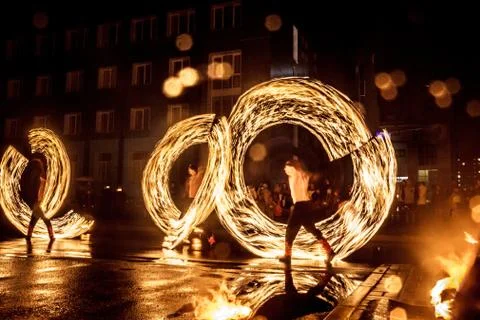 Night performance fire show in front of a crowd of people on the street in Ru Stock Photos