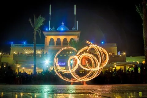 Night performance fire show in front of a crowd of people on the street in Eg Stock Photos
