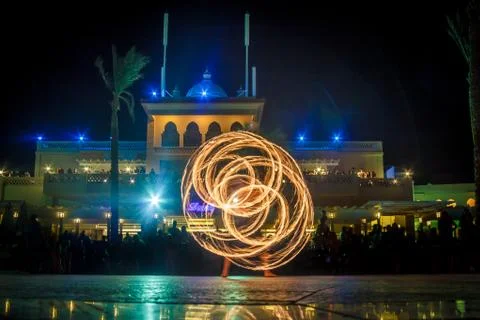 Night performance fire show in front of a crowd of people on the street in Eg Stock Photos