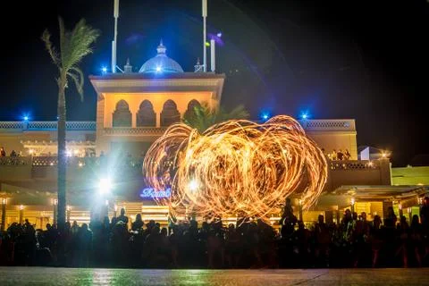 Night performance fire show in front of a crowd of people on the street in Eg Stock Photos