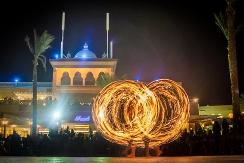 Night performance fire show in front of a crowd of people on the street in Eg Foto stock