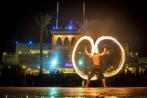 Night performance fire show in front of a crowd of people on the street in Eg Foto stock