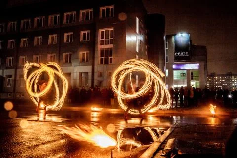 Night performance fire show in front of a crowd of people on the street in Ru Stock Photos