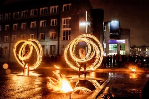 Night performance fire show in front of a crowd of people on the street in Ru Stock Photos