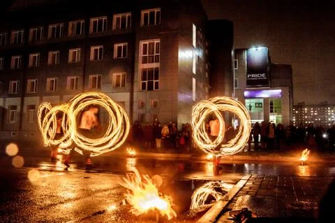 Night performance fire show in front of a crowd of people on the street in Ru Stock Photos