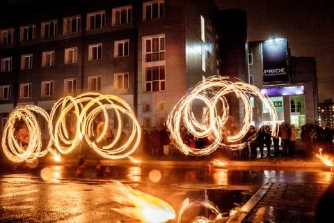 Night performance fire show in front of a crowd of people on the street in Ru Stock Photos