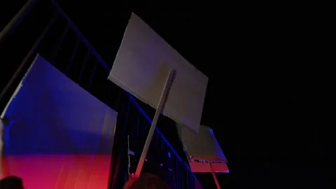 Night Protest Scene with Moving Sign and Siren-Like Light Flashes, Cinematic 스톡 동영상 331826635