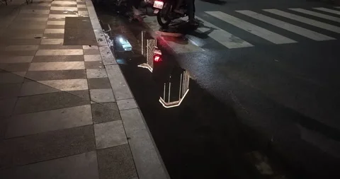 Night puddle reflection of a motorcycle silhouette and luxury hotel Stock Footage 334128018