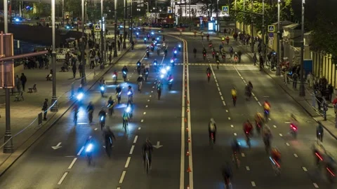 Night race of cyclists through the Central streets of the city,time lapse Stock Footage 146840567