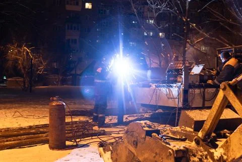 Night Repair Work on a Heating Main in Kyiv During Blackout Stock Photos