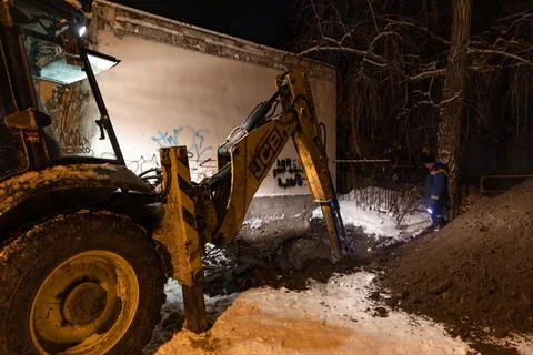 Night repair work on a heating network in Kyiv during winter blackouts Stock Photos