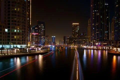 Night river traffic long tracers in Dubai UAE center along a city river with Stock-Fotos