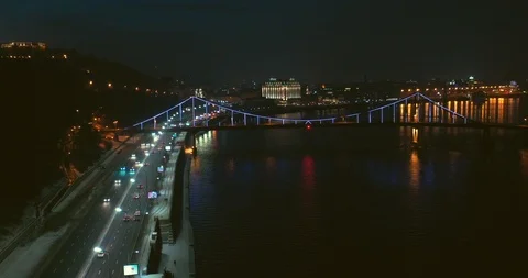 Night River  View On Colorful Rainbow Pedestrian Bridge With traffic on highway Stock Footage 112985553