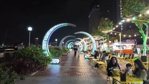 Night riverside promenade large patterned arches, planted areas — Da Nang Stock Footage 347670543