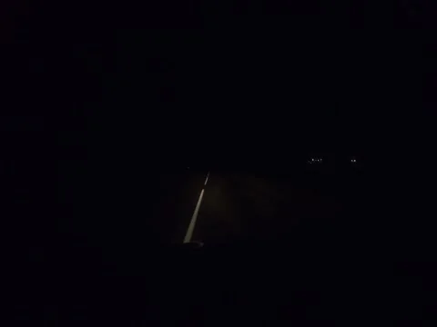 Night road from the front side illuminated by car headlights. Stock Footage 221789137