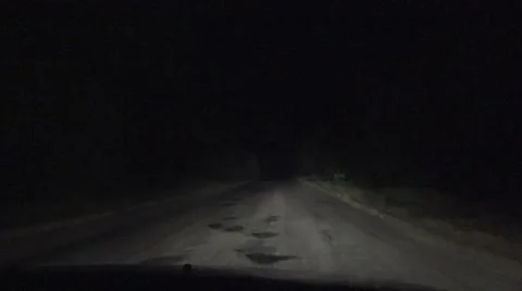 Night road, highway through tunnel of trees, light of car headlights, 4k Stock Footage 55911149