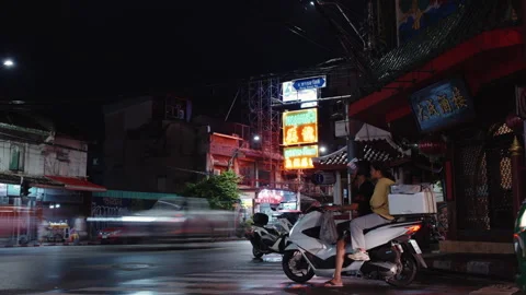 Night road intersection in Chinatown after the rain. People, cars and motorbikes Stock Footage 247007086