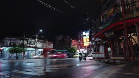 Night road intersection in Chinatown after the rain. People, cars and motorbikes Stock Footage 249927442
