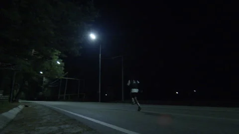 Night Run — Young Athlete on Empty Street Stock Footage 314644236