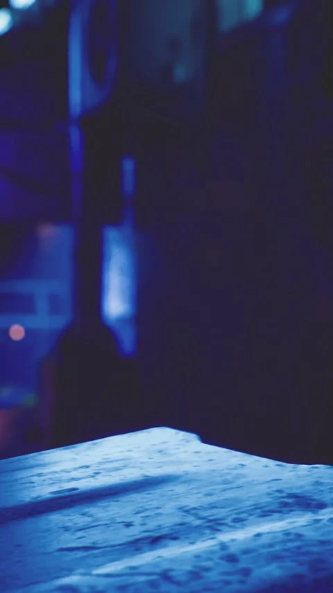 Night scene with blue light and empty table in a dim space Stock Footage 332233197