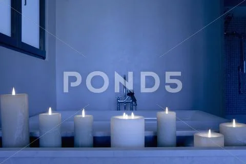 Night Scene With A Collection Of Lit Candles In Front Of A Bathtub