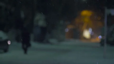 Night scene with falling snowflakes on blurred background of city 스톡 동영상 71498055