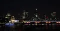 Night Scene of London City Skyline wit Cars Traffic and Ferryboats UK Landmarks 4k or 4k+ Resolution