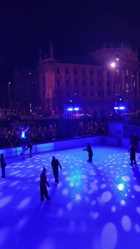Night scene at the Münchner Eiszauber ice rink in the center Stock Footage 323522218