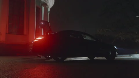 Night scene, trunk of a car opens automatically, woman takes a sparkling dress Stock Footage 236422035