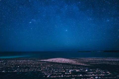 Night seascape, starry sky and sandy beach, Cyprus Stock Photos