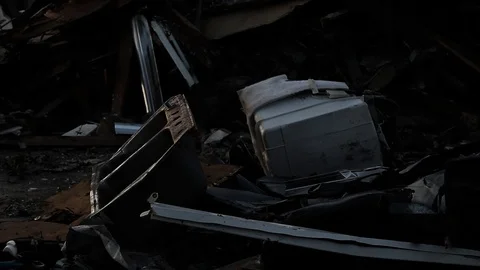 Night sets over a pile of trash Stock Footage 95108077