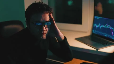 Night Shift Man Analyzing Graphs on Calculator at Workstation Stock Footage 232412204