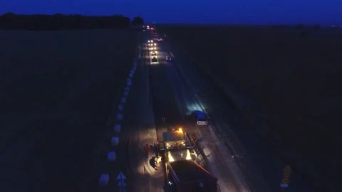 Night shift work .48 hours. Asphalt paver, roller and truck at the repair site Stock Footage 229673946