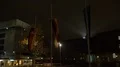 Night shot city street scenery flags in front of a town hall 4k or 4k+ Resolution