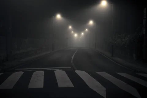 Night shot of a desolate, empty and abandoned city street with streetlights.. Stock-Fotos