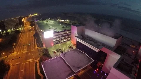 Night shot, flying backwards and revealing the huge neon guitar and Biloxi Hard Stock Footage 90643306