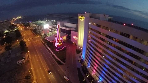 Night shot, hovering beside the Hard Rock Hotel, looking at the huge neon guitar Stock Footage 90561019