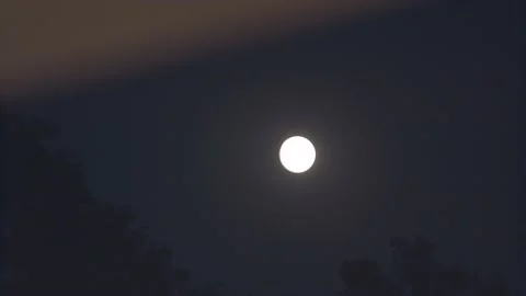 A night shot of the moon seen from a window Stock Footage 135399878